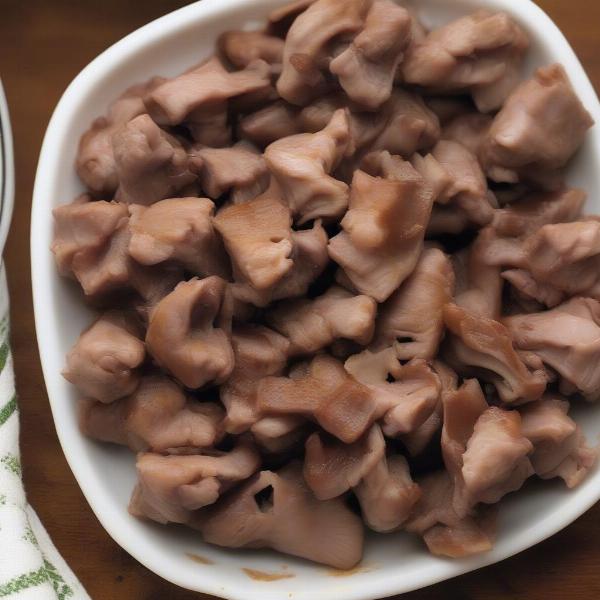 Plate of cooked turkey gizzards prepared for a dog