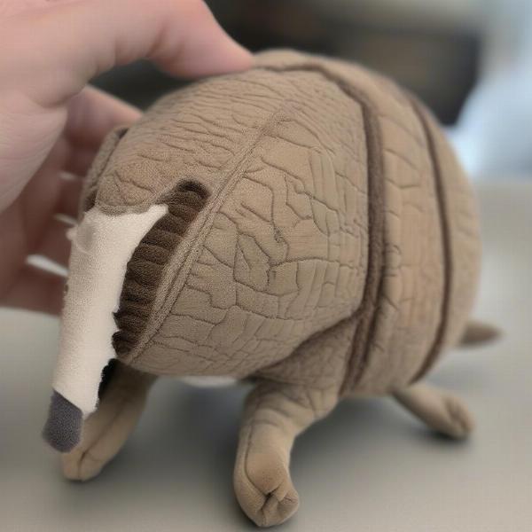 A damaged armadillo toy that needs replacing