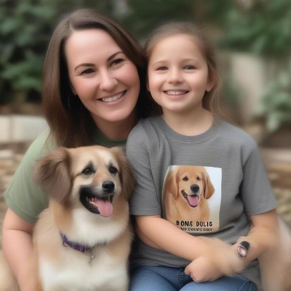 A dog mom happily wearing a t-shirt featuring her dog while cuddling with her furry friend.