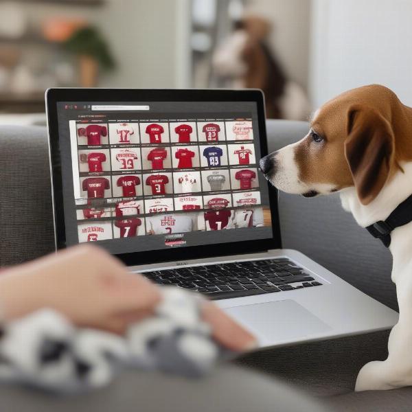 A person browsing Alabama dog jerseys on a laptop