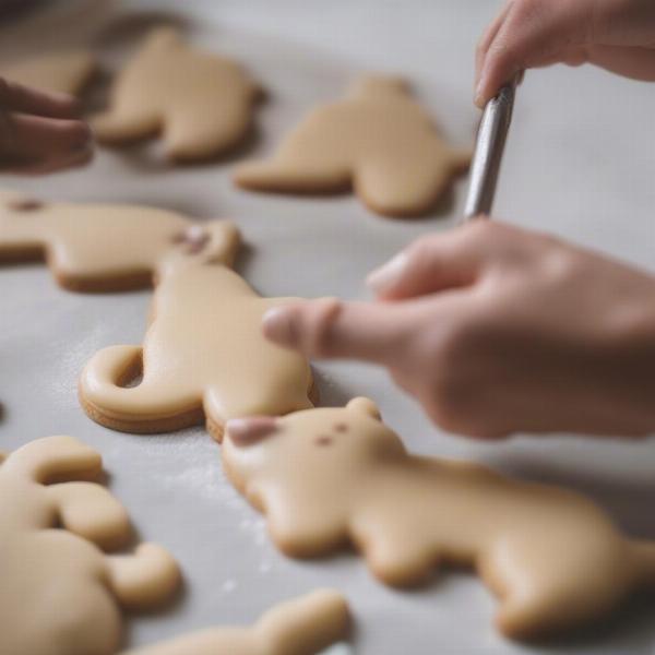 Applying icing to dog cookies