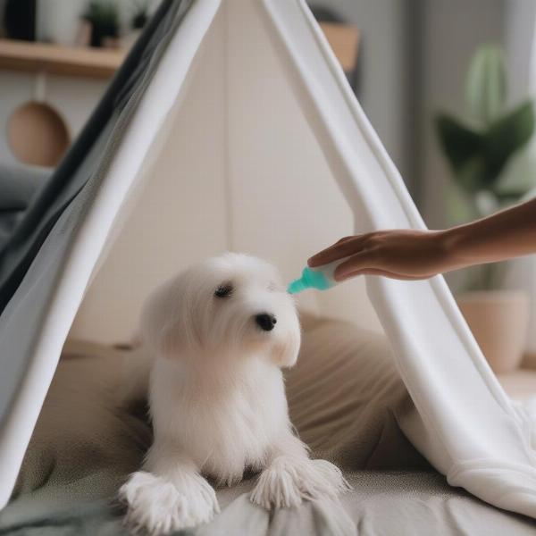 A person cleaning a dog teepee bed.