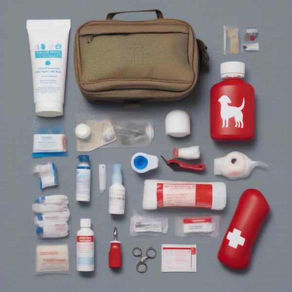 A dog first-aid kit opened to display its contents: antiseptic wipes, bandages, gauze, tweezers, scissors, and medications.