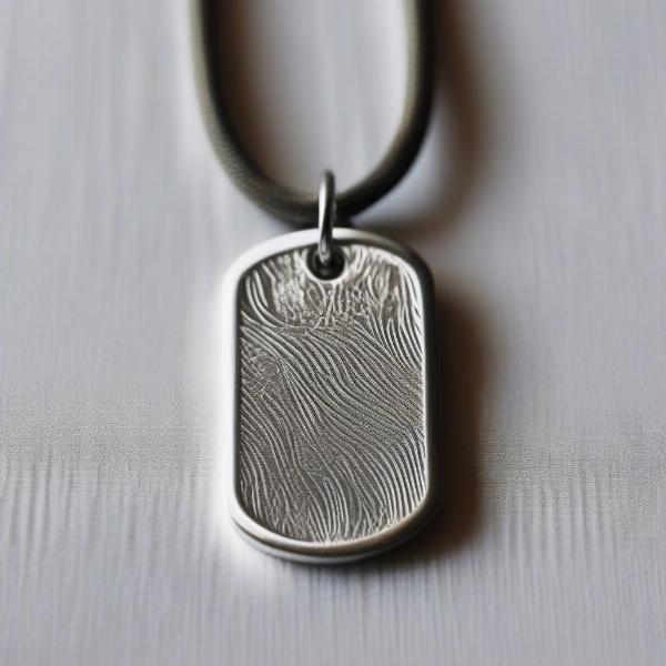 Close-up of a dog tag with a fingerprint engraved on it