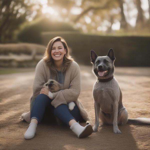 A happy dog sitting next to their dog sitter, both smiling at the camera